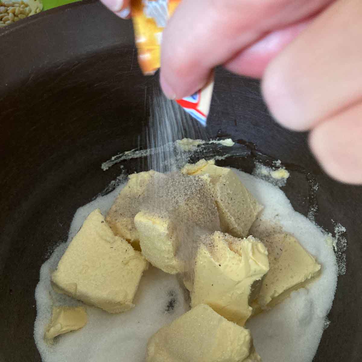 Butter and sugar in mixing bowl.